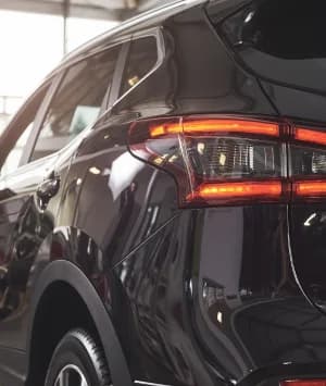 A person entering car details on a laptop