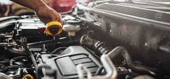A mechanic checking the engine of a car