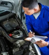 A mechanic checking the tires of a car