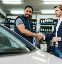 A mechanic inspecting a car